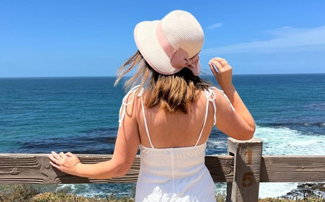 A lady wearing a LC Lauren Conrad Straw Split Back Cloche Hat