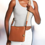 A lady with Michael Kors Jet Set Travel Small Messenger Bag