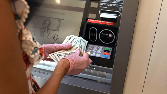 A lady withdrawing cash from ATM