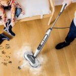 A person cleaning a floor using a Shark Steam Scrub Steam Mop