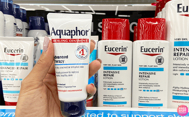 A person holding Aquaphor Healing Ointment