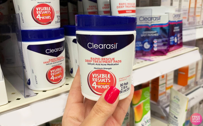 A person holding a Clearasil Salicylic Acid Acne Pads