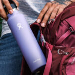 A person holding a Hydro Flask 21 oz Stainless Water Bottle