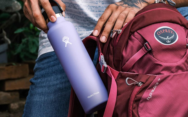 A person holding a Hydro Flask 21 oz Stainless Water Bottle