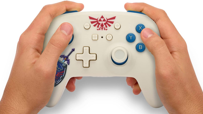 A person holding a Legend of Zelda Nintendo Switch Wireless Controller