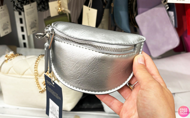 A person holding a Universal Thread Belt Bag Pouch Wristlet in silver color