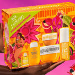 A person holding a box of Sol De Janeiro Hydration Celebration Body Routine Gift Set