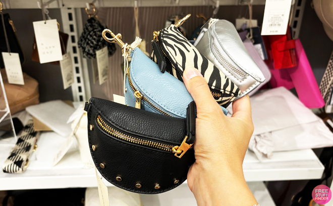 A person holding four Universal Thread Belt Bag Pouch Wristlets