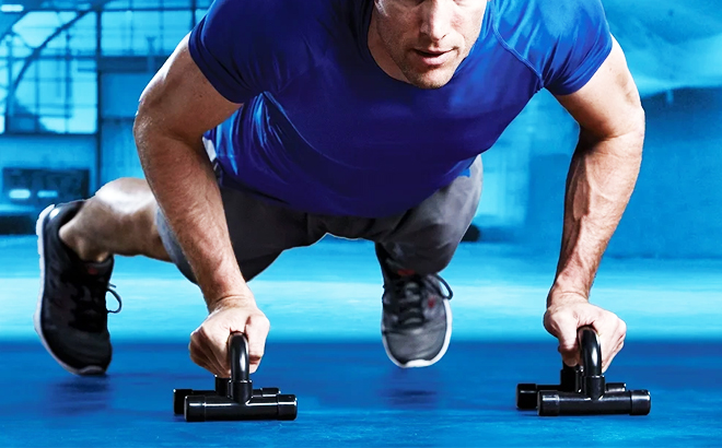 A person performing a push up working using a SPRI Home Gym Essentials Kit