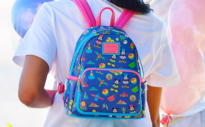 A person slinging a Mickey Mouse and Friends Loungefly Mini Backpack