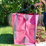 A person using a Improvements Heavy Duty Home Lawn Bag