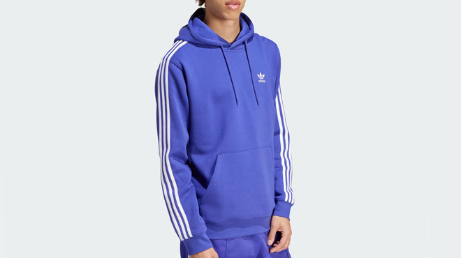 A person wearing a Adidas Adicolor 3 Stripes Hoodie