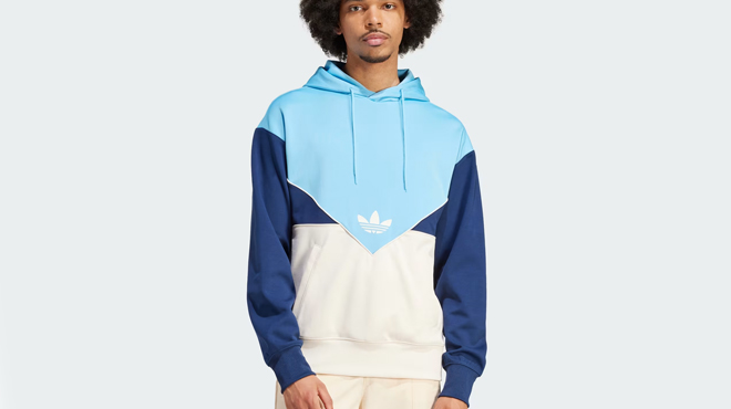 A person wearing a Adidas Adicolor Cutline Hoodie