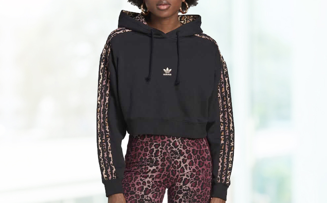 A person wearing a Adidas Womens Hoodie Logo