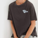 A person wearing a Aerie Graphic Oversized Boyfriend T Shirt in black