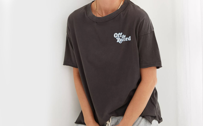 A person wearing a Aerie Graphic Oversized Boyfriend T Shirt in black