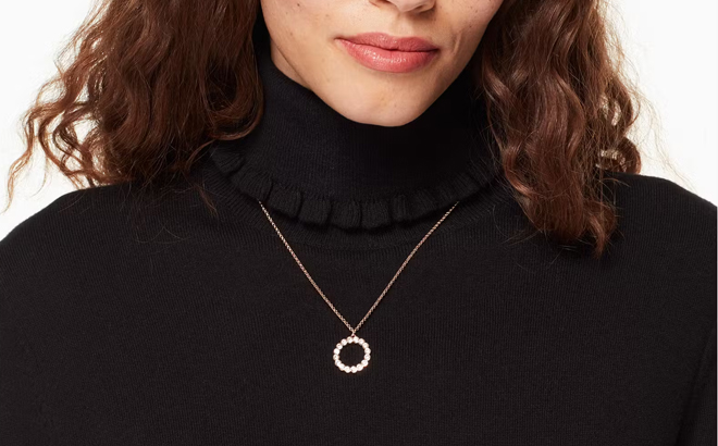 A person wearing a Kate Spade Full Circle Mini Pendant