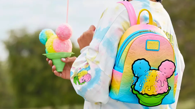 A persong slinging a Disney Mickey Mouse Shaved Ice Loungefly Mini Backpack