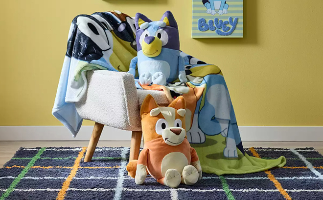 Bluey Pillow Buddy on an Armchair and Bluey Bingo Pillow Buddy in front of an Armchair