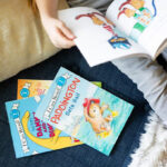 Books next to a Kid Reading a Book