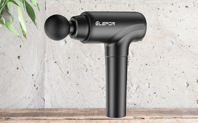 Elegor Deep Tissue Massage Gun in Black on a Table