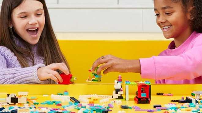 Girls playing with LEGO blocks