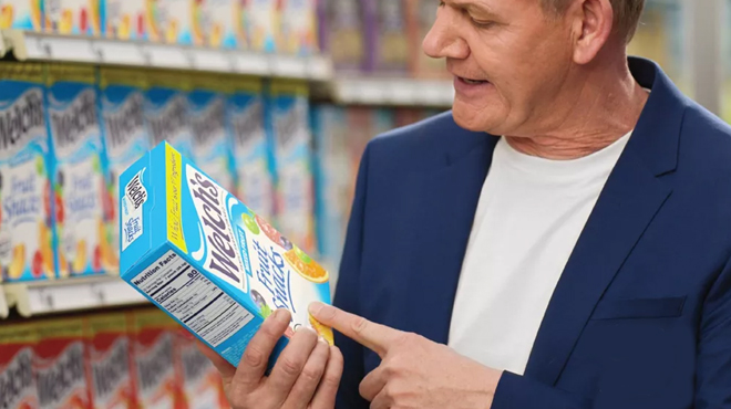 Gordon Ramsey holding a box of WELCHS Fruit Snacks Mixed Fruit