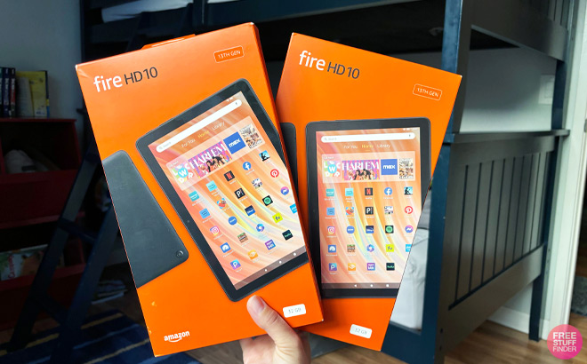 Hand Holding two Amazon Fire HD 10 Tablets