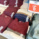 Old Navy Long Sleeve T Shirts Folded on a Shelf with a Price Sign