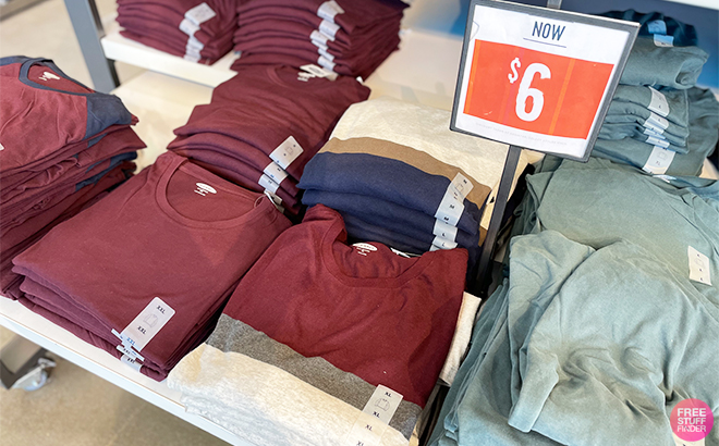 Old Navy Long Sleeve T Shirts Folded on a Shelf with a Price Sign