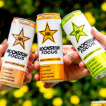 People Holding Rockstar Energy Drink Cans