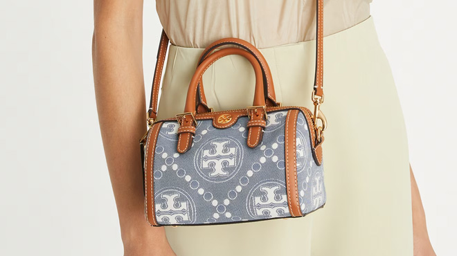 a Person Wearing Tory Burch T Monogram Denim Petite Barrel Bag