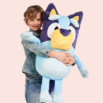 A Child Holding the Bluey My Size Bluey 36 Inch Plush