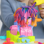 A Child Playing With The Play Doh Hair Stylin Salon Playset