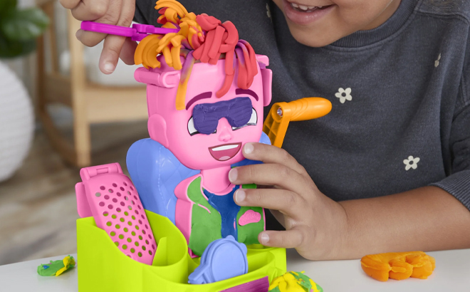 A Child Playing With The Play Doh Hair Stylin Salon Setjpg