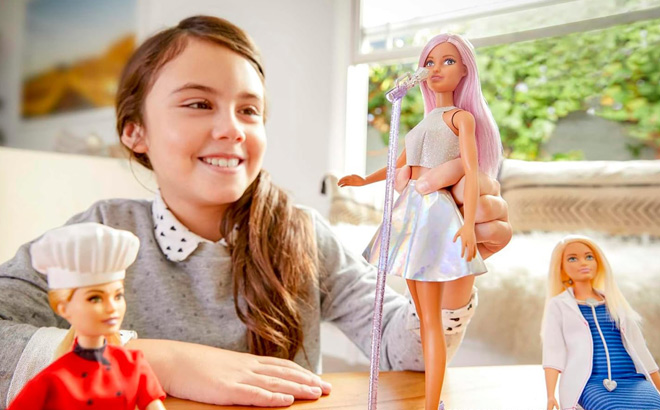 A Child Playing with Barbie Pop Star Doll