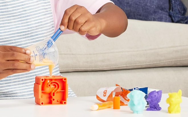 A Child Playing with Elmers Squishies 24 Piece Kit