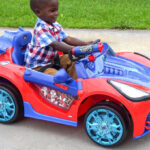 A Child Riding a Spider Man Ride On Car