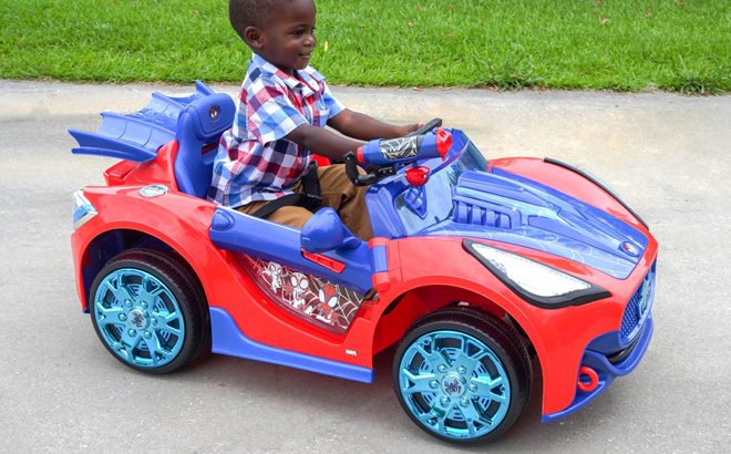 A Child Riding a Spider Man Ride On Car