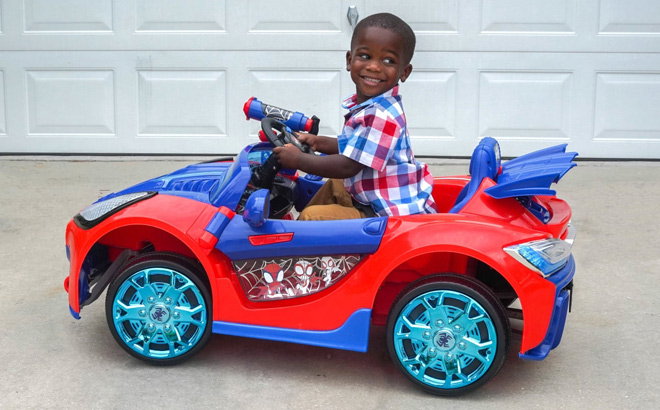 A Child Riding a Spider Man Ride On