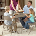 A Family Sitting on the Mainstays All Steel Metal Folding Chairs in Beige 4 Pack