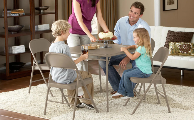 A Family Sitting on the Mainstays All Steel Metal Folding Chairs in Beige 4 Pack