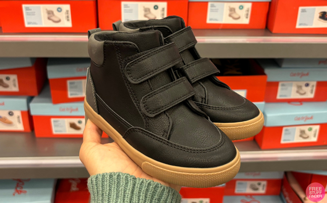 A Hand holding Cat Jack Toddler Xavier High Top Sneakers