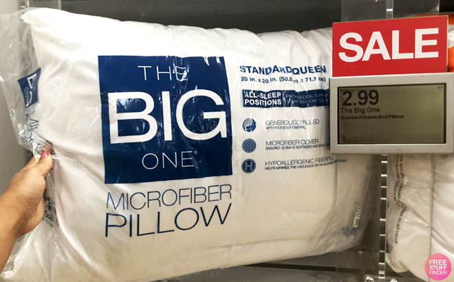 A Hand holding The Big One Queen Size Microfiber Pillow