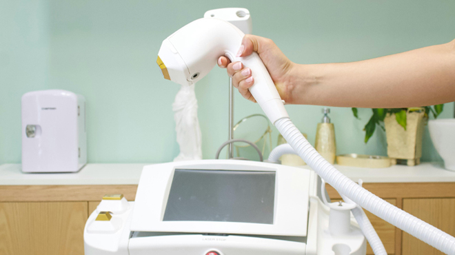 A Hand holding a Laser Hair Removal Device