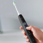 A Hand holding a Philips Sonicare Electric Toothbrush