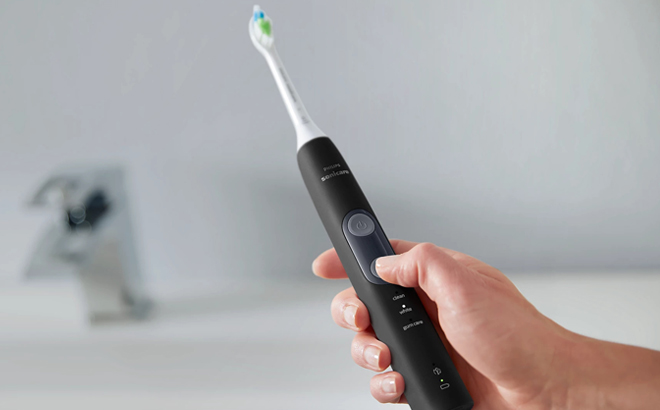 A Hand holding a Philips Sonicare Electric Toothbrush