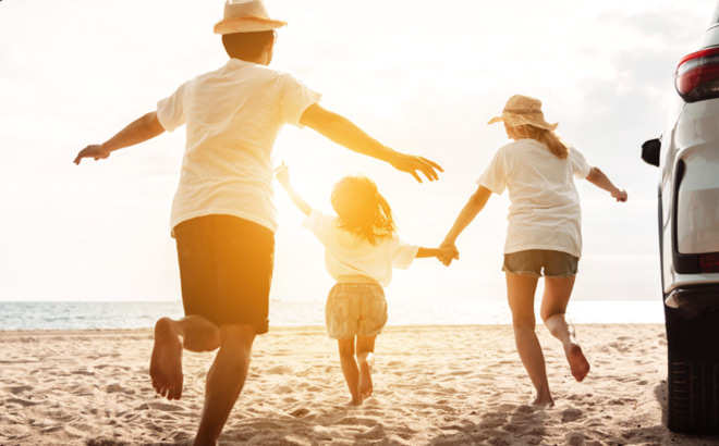 A Happy Family Running on a Beach