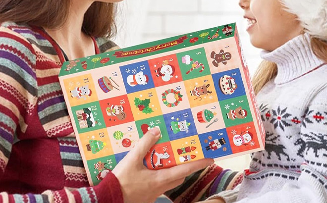 A Person Holding Advent Calendar with Straw Toppers