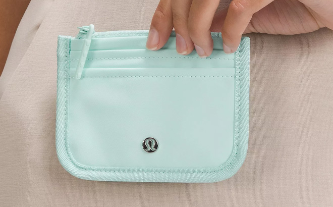 A Person Holding Lululemon True Identity Card Case in Mint Color